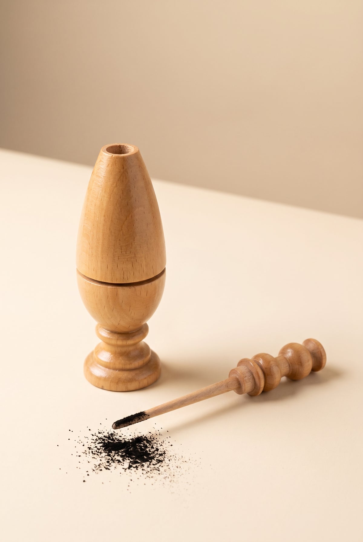 Beech wood kohl applicator shown open with the applicator stick dipped in kohl