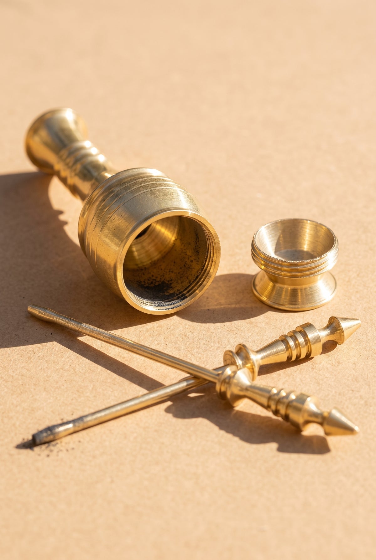 Egyptian copper kohl applicator opened into three pieces: body, screw-off base and applicator stick