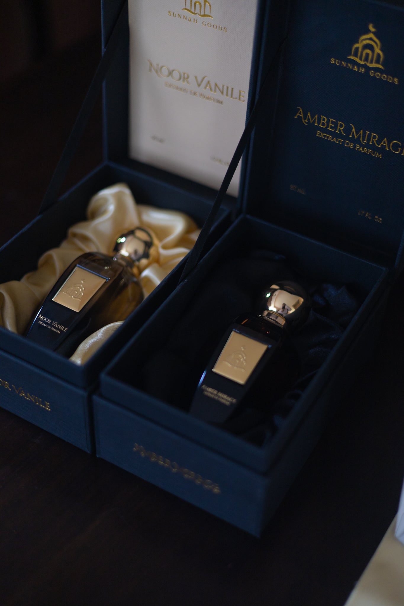 Two perfume bottles in a blue box with 'Amber Mirage' branding.