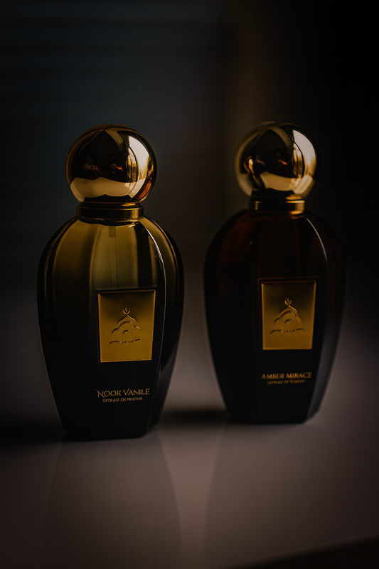 Two black perfume bottles with gold caps on a dark background