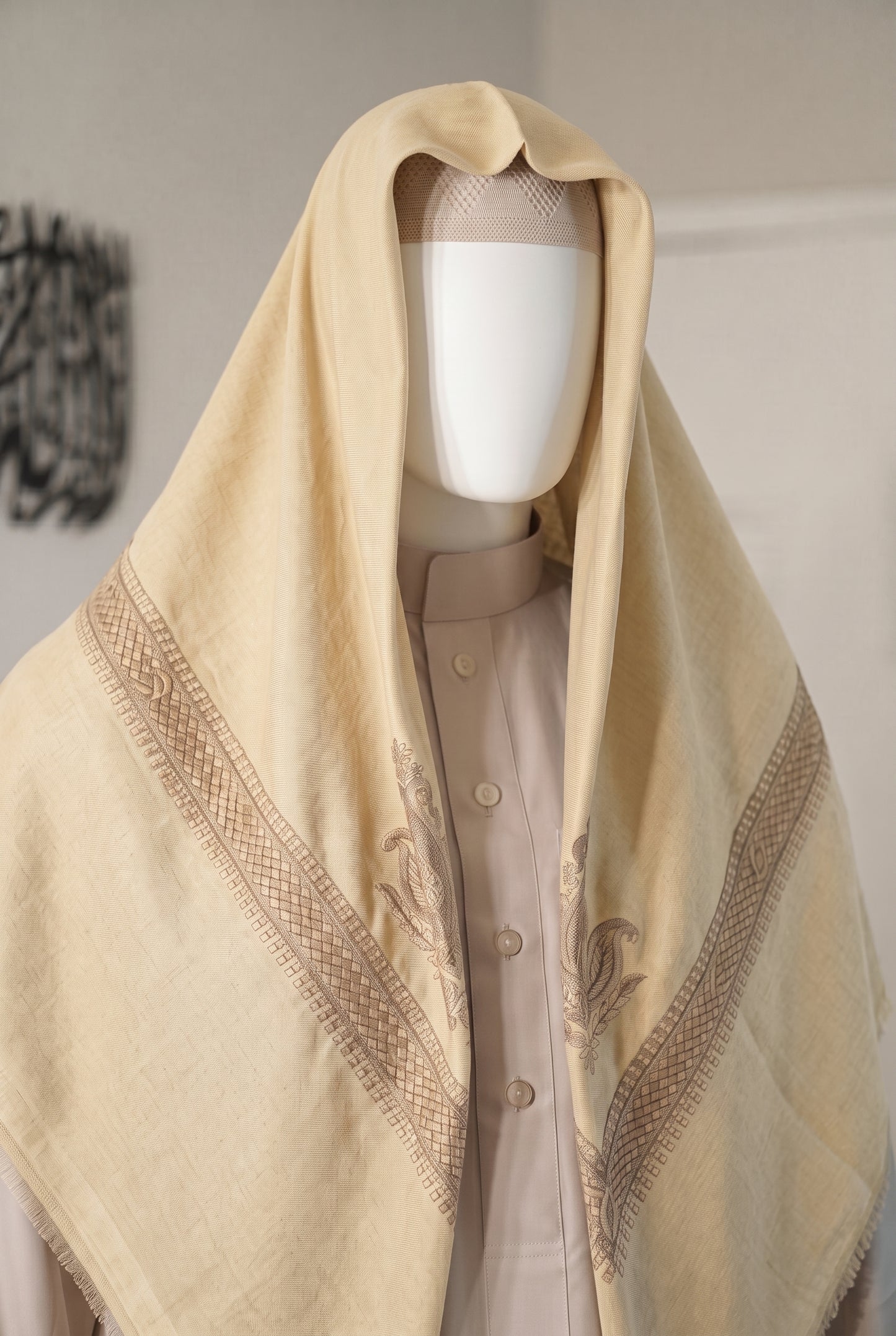 Desert Sun butter cream shemagh with maroon embroidered border on mannequin