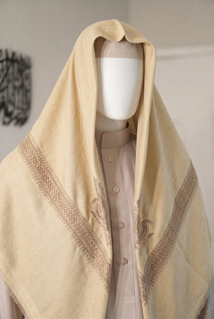 Desert Sun butter cream shemagh with maroon embroidered border on mannequin