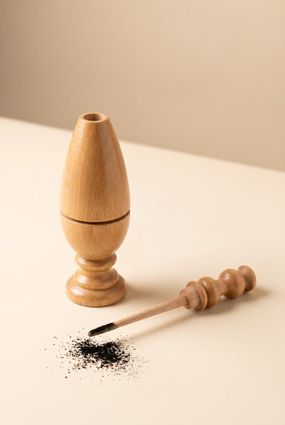 Beech wood kohl applicator shown open with the applicator stick dipped in kohl