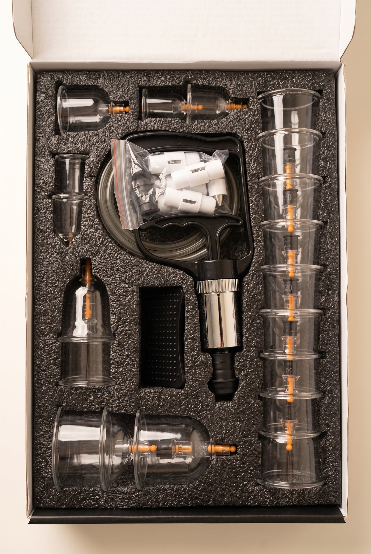 Theracups hijama cupping set open in its box with cups, pump and accessories in a foam insert