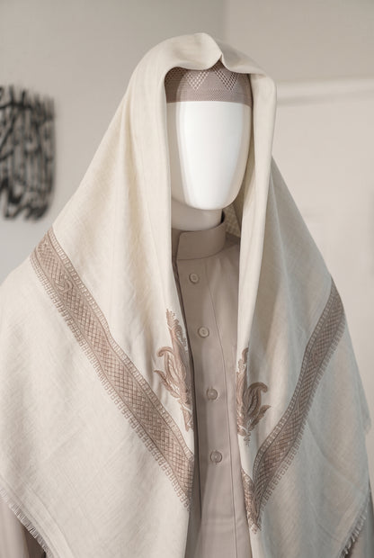Pearl white shemagh with navy embroidered trim draped on mannequin