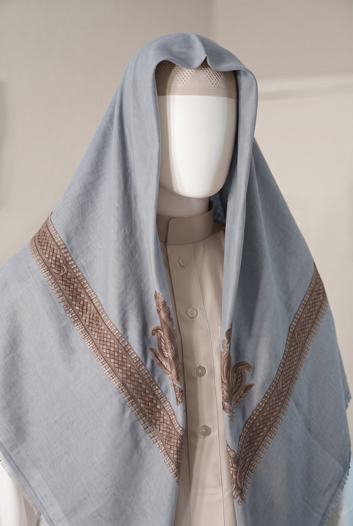 Dawn powder blue shemagh with embroidered trim draped on mannequin