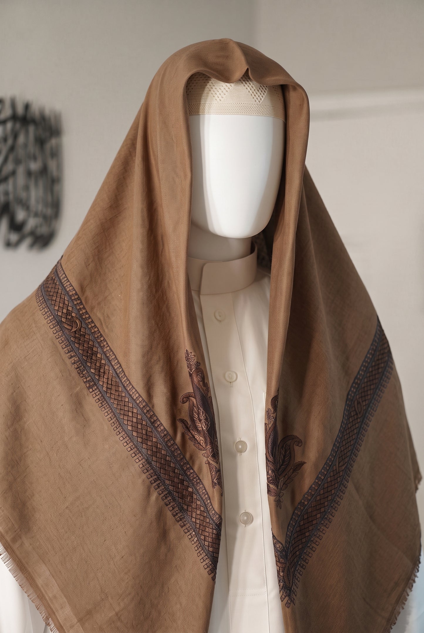 caramel shemagh with brown embroidery worn on mannequin, front view