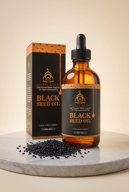 Sunnah Goods cold-pressed Black Seed Oil 240ml amber bottle and box with black seeds on marble