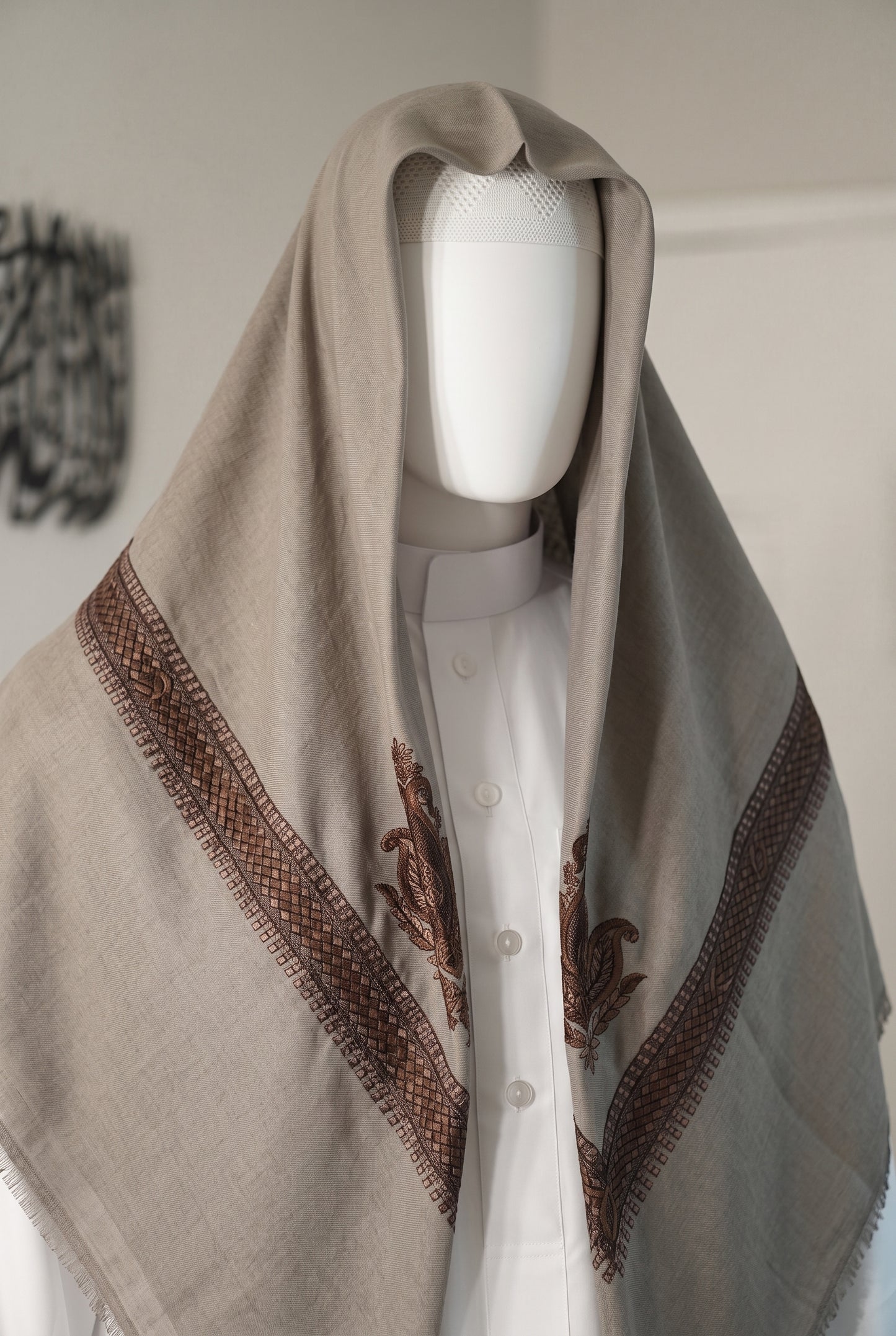 cashmere color shemagh with gold embroidered border styled on white mannequin