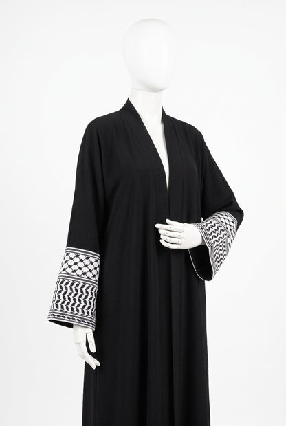 Black Palestine heritage keffiyeh cuff abaya in linen crinkle on a mannequin