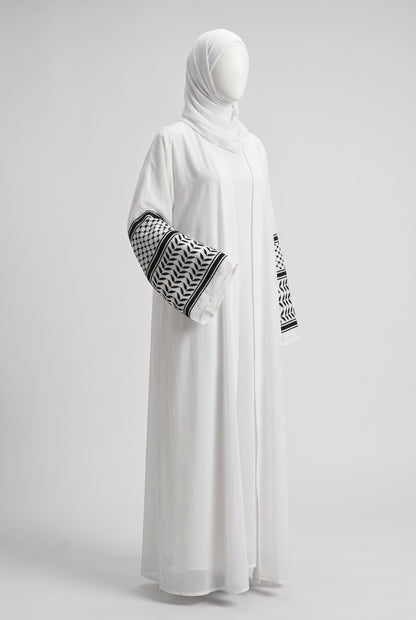 White Palestine heritage keffiyeh cuff abaya in linen crinkle on a mannequin