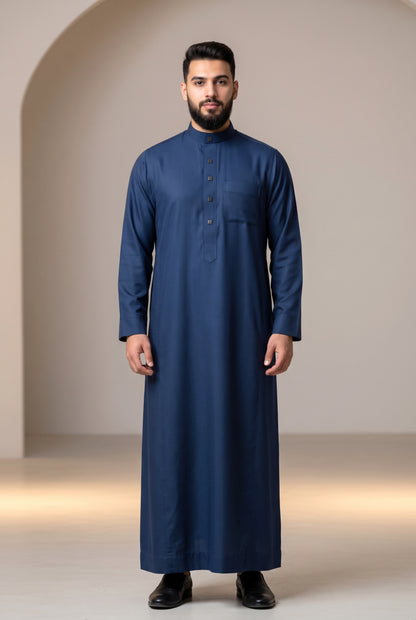 Man wearing a navy blue Al Aseel winter thobe
