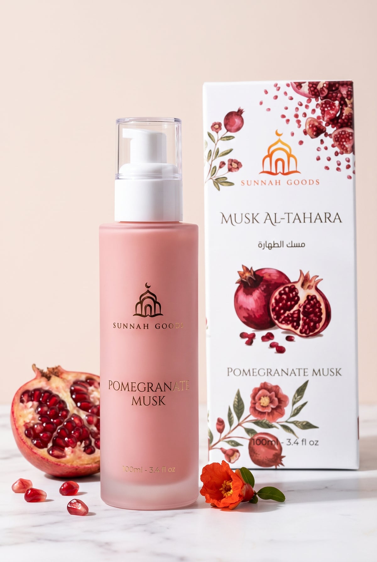 Musk Al Tahara Pomegranate Musk 100ml pink frosted glass pump bottle with its pomegranate gift box and a halved pomegranate
