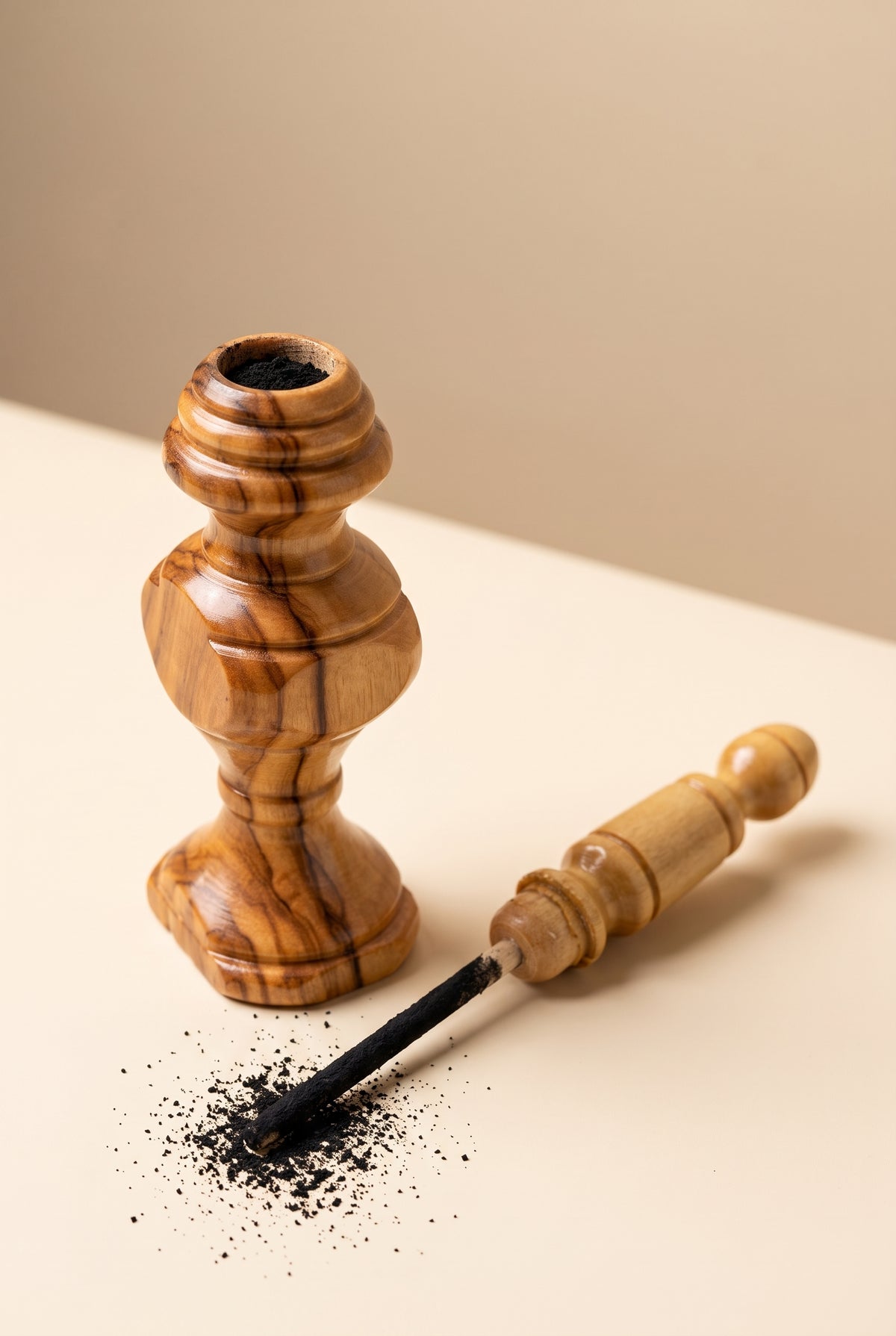 Olive wood kohl applicator shown open with the applicator stick dipped in kohl