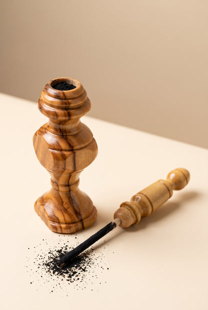 Olive wood kohl applicator shown open with the applicator stick dipped in kohl