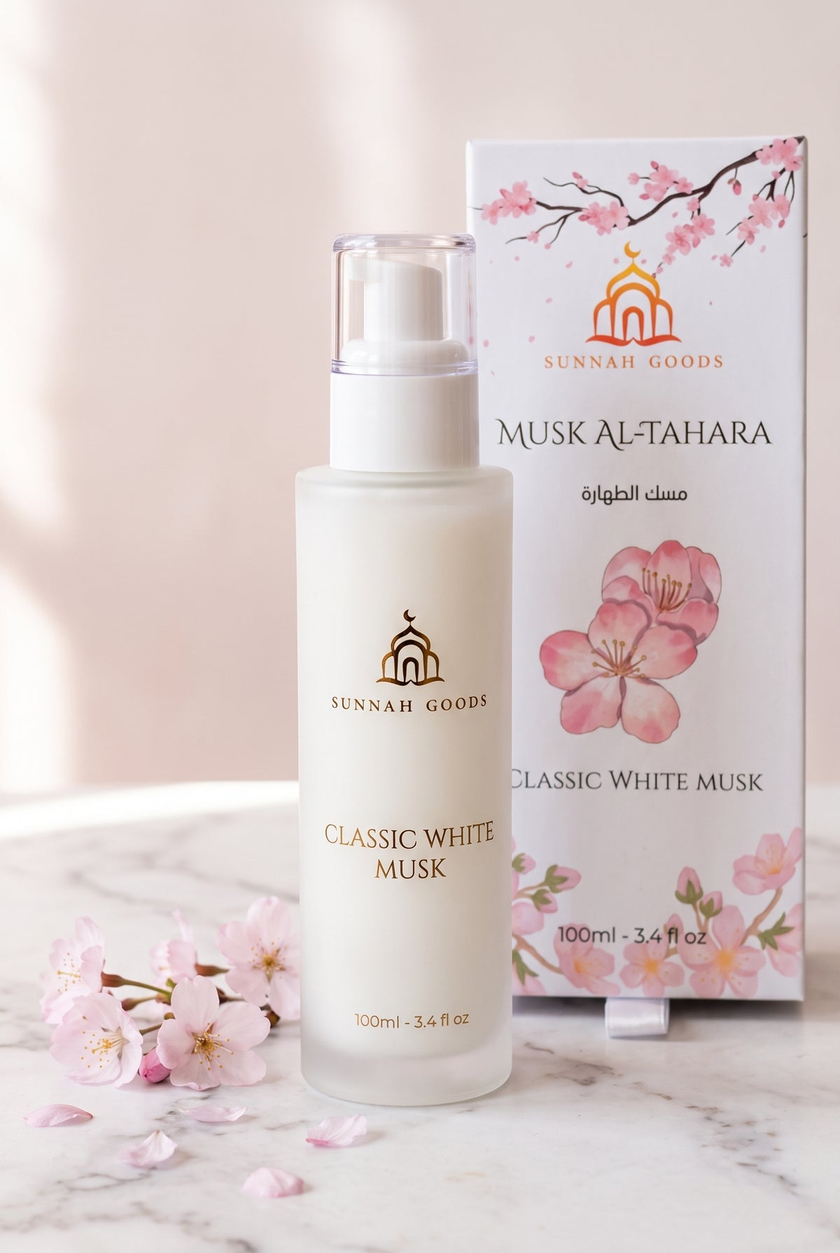Musk Al Tahara Classic White Musk 100ml frosted glass pump bottle with its cherry blossom gift box and pink petals on marble