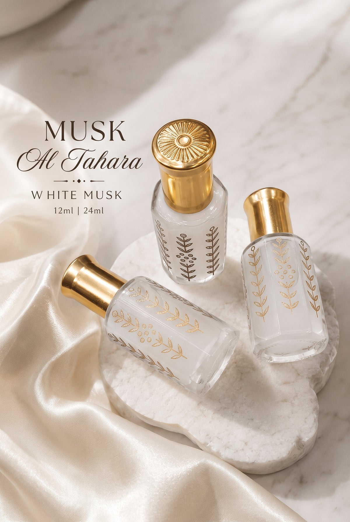 Musk Al Tahara white musk in clear glass bottles with gold caps on white satin