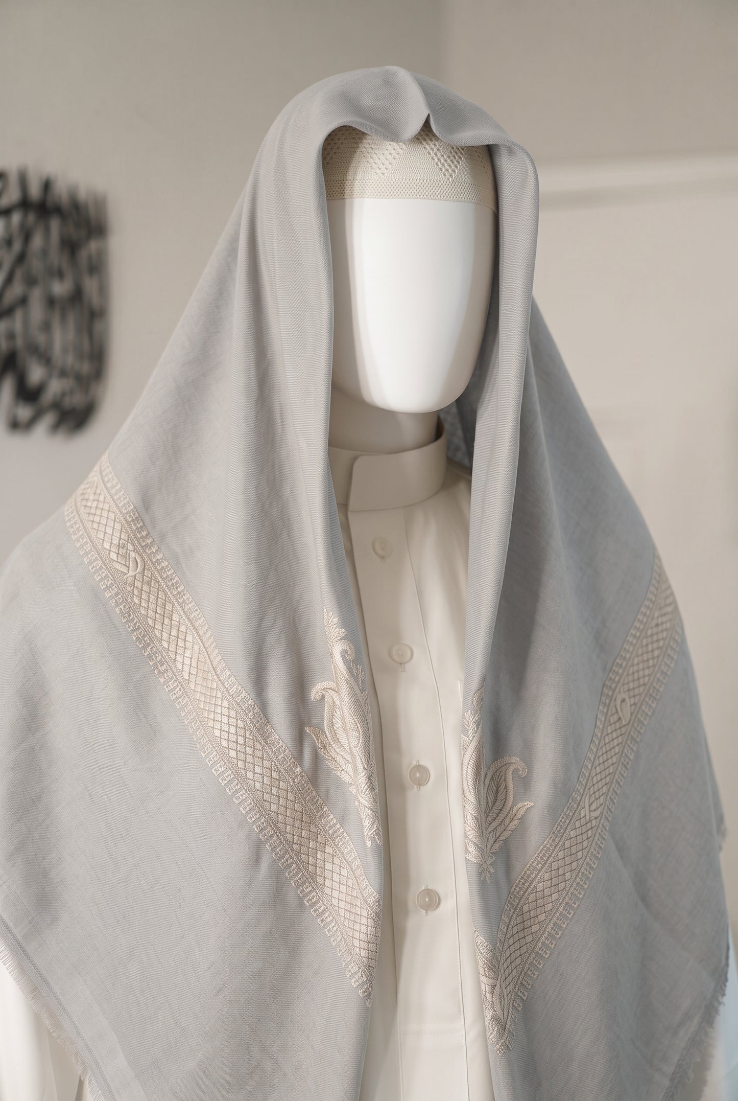 Dune silver grey shemagh with blue embroidered border on mannequin