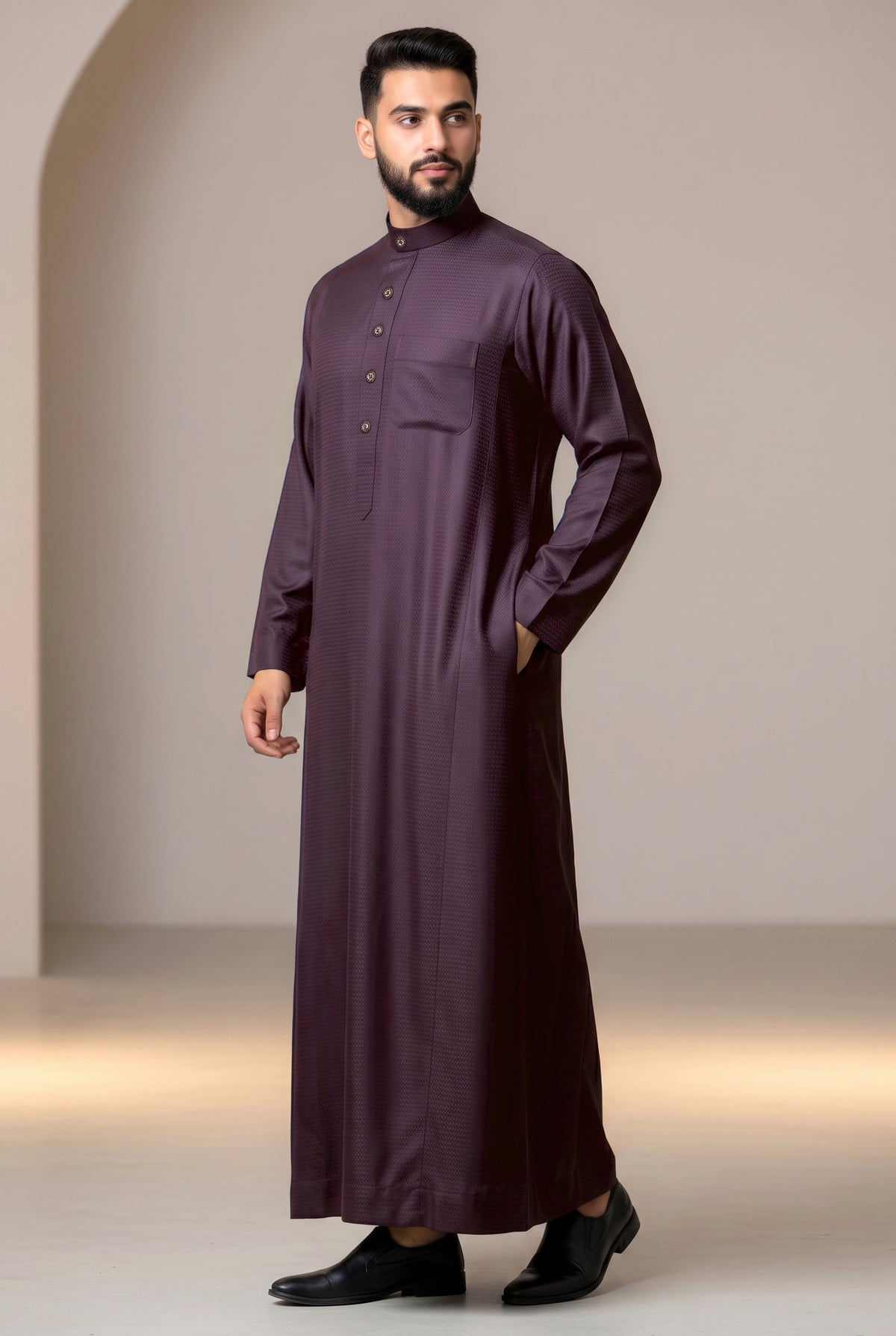 Man wearing a burgundy Al Aseel winter thobe, full length