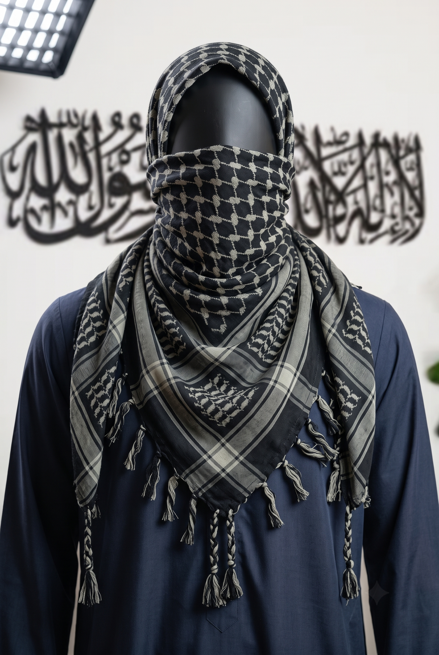 Man wearing Ashfall keffiyeh, black and sage grey cotton shemagh scarf, traditional head wrap, studio portrait